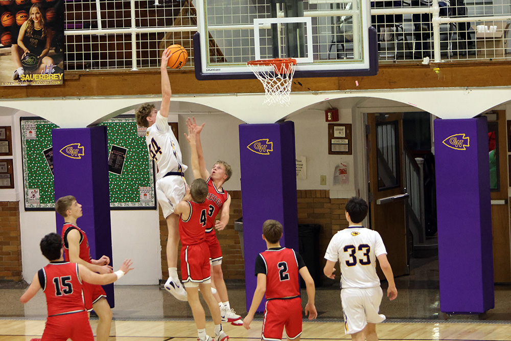 Sophomore Landon Justice rises up to score over a Neoga defender. Justice dominated the JV contest with 20 points and 13 rebounds. —photo by Terri Cox