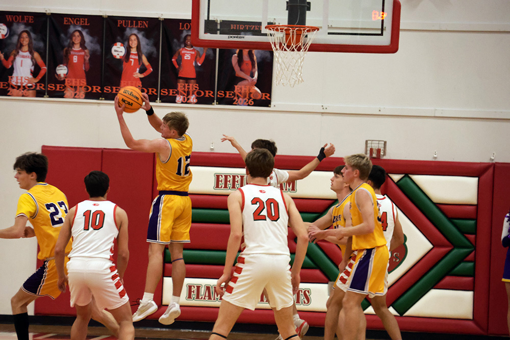 Warrior Nolan Clement battles for position in the paint against Effingham. Clement pulled down five rebounds and dished out six assists in the season-opening win. —photo by Terri Cox