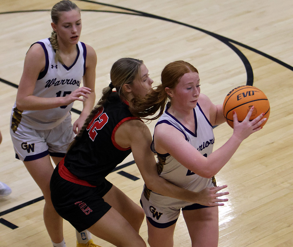 Lady Warrior Madison Gray secures an offensive rebound in traffic during Mega Night action at Bob Durham Court. —photo by Terri Cox